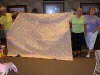 Ceil being presented with a quilt from Chatham Quilters