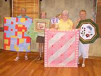 A group show and tell, from left to right, Alice Bessler, Andrea Lasik, Vilma Baragona, Margo McClary, and Kay Hasson.
