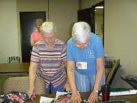 Phyllis Baily (teacher) helping Cora Vennes with her landscape quilt