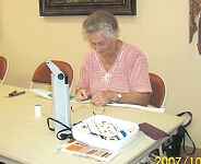 Rita Pickard hand appliqueing her latest project.