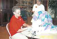 Ruth Hodsdon (sitting) showing Flossie Waldron her latest quilt in progress.
