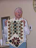 Joan Keener showing her half table runner.