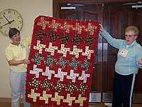 Marilyn Gushen showing the snack quilt she made for her son-in-law for Christmas.